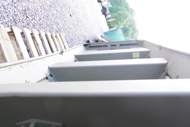 Slide: The Image of 2026 G3 Gator Tough 1436 boat interior with metal framework and gravel background. - 11