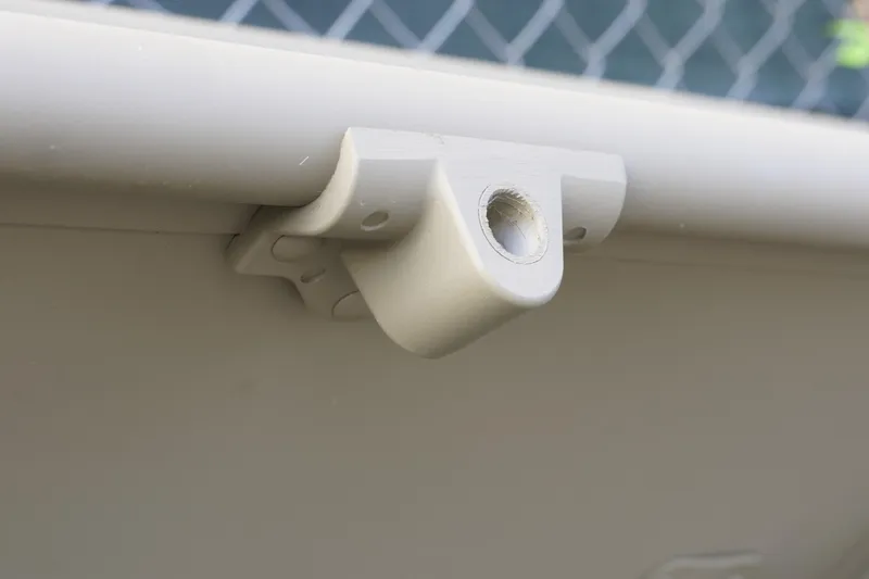 Slide: The Image of Close-up of a 2026 G3 Gator Tough 1436 boat component against a chain-link fence. - 9