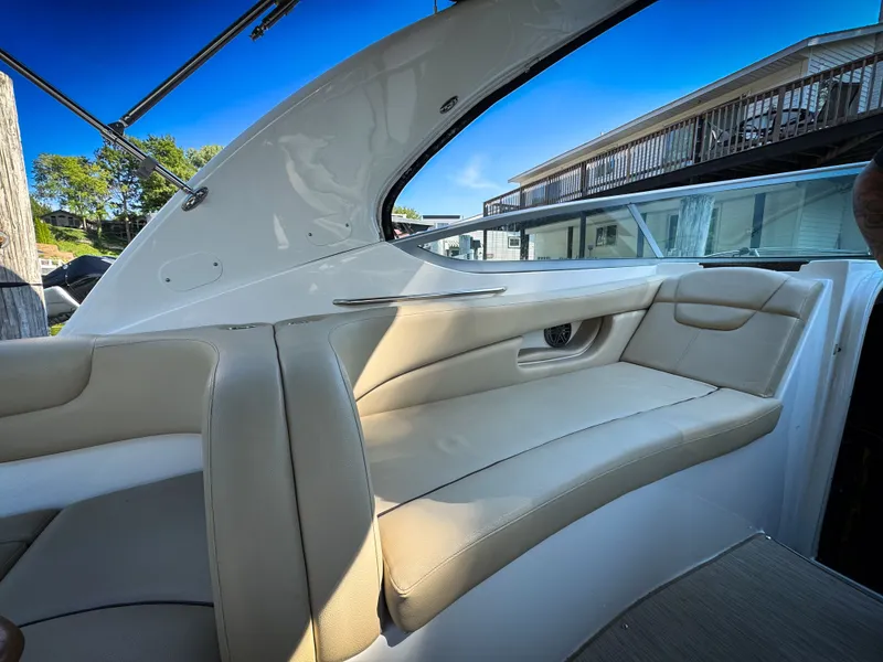 Slide: The Image of 2016 Rinker 290 Express boat interior with beige seating and sleek design. - 24