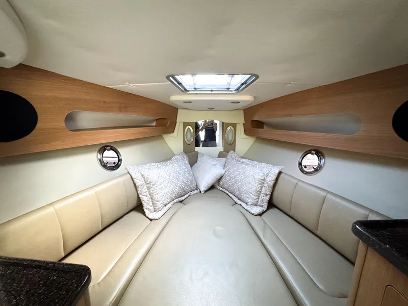 Slide: The Image of Interior of 2016 Rinker 290 Express boat with cozy seating and pillows. - 3