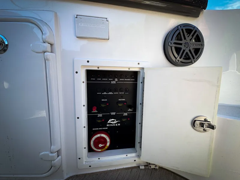 Slide: The Image of 2016 Rinker 290 Express control panel with open door and speaker. - 33