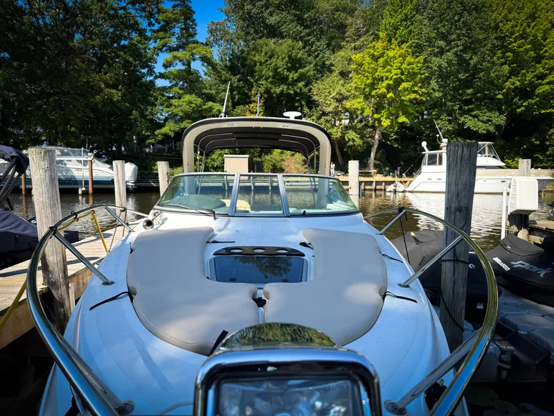 Slide: The Image of 2016 Rinker 290 Express boat docked in a serene marina setting. - 7