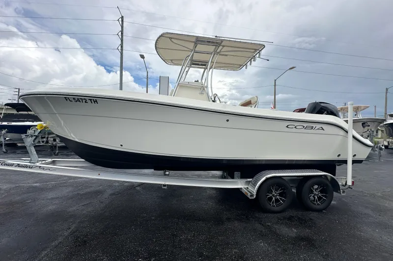 Slide: The Image of 2022 Cobia 237 Center Console boat on trailer, parked outdoors. - 10