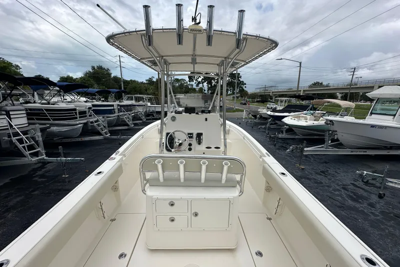Slide: The Image of 2022 Cobia 237 Center Console boat in a marina, surrounded by other boats. - 13