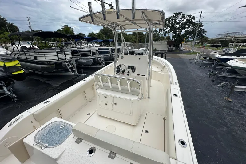 Slide: The Image of 2022 Cobia 237 Center Console boat with spacious deck and modern controls. - 14