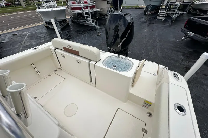 Slide: The Image of 2022 Cobia 237 Center Console boat with Mercury engine, featuring spacious deck and storage. - 15