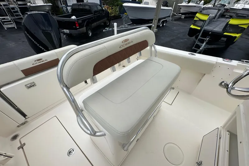 Slide: The Image of 2022 Cobia 237 Center Console boat interior with cushioned seating and storage compartments. - 18