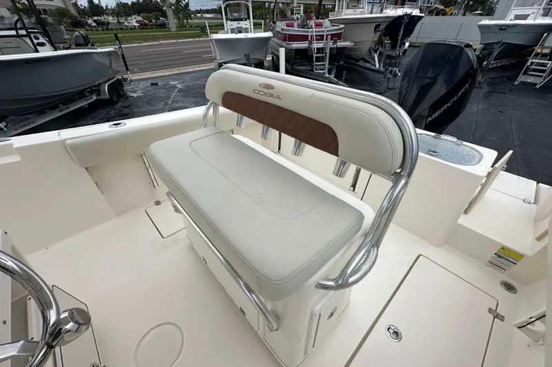 Slide: The Image of 2022 Cobia 237 Center Console boat interior with cushioned seating and stainless steel accents. - 19