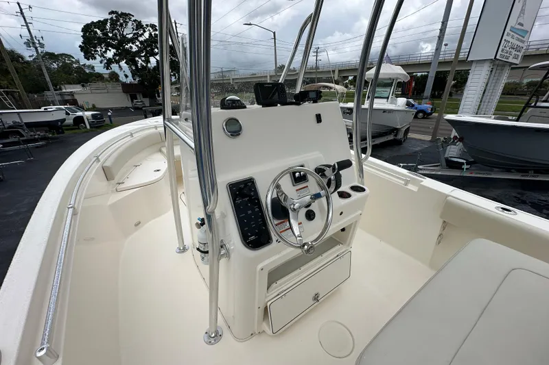 Slide: The Image of 2022 Cobia 237 Center Console boat interior with steering wheel and controls. - 20