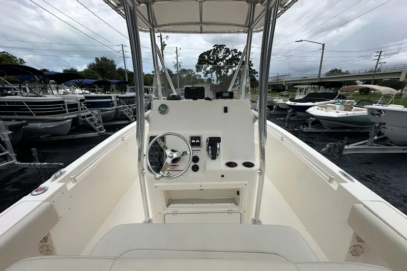 Slide: The Image of 2022 Cobia 237 Center Console boat interior with steering wheel and controls. - 21