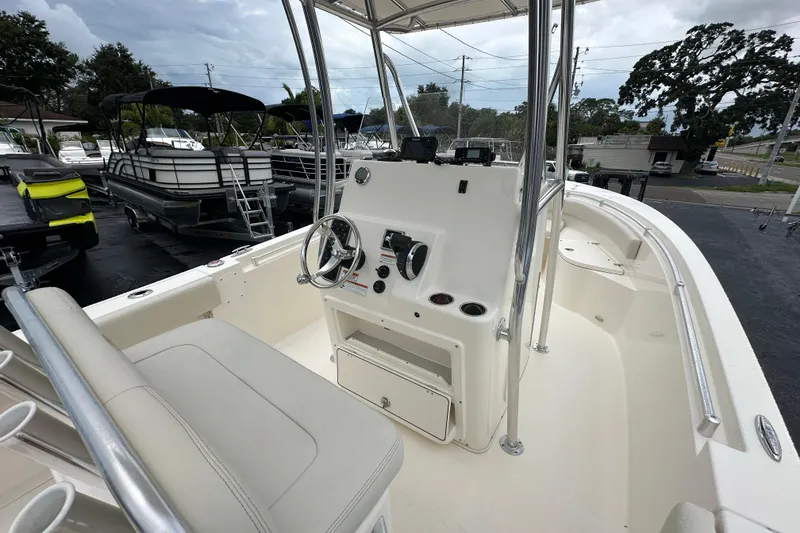 Slide: The Image of 2022 Cobia 237 Center Console boat interior with steering wheel and seating. - 22