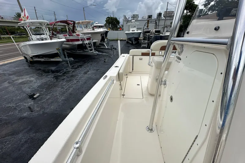 Slide: The Image of 2022 Cobia 237 Center Console boat on display at a dealership. - 25