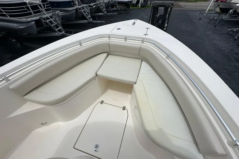 Slide: The Image of 2022 Cobia 237 Center Console boat with cushioned seating and storage. - 27