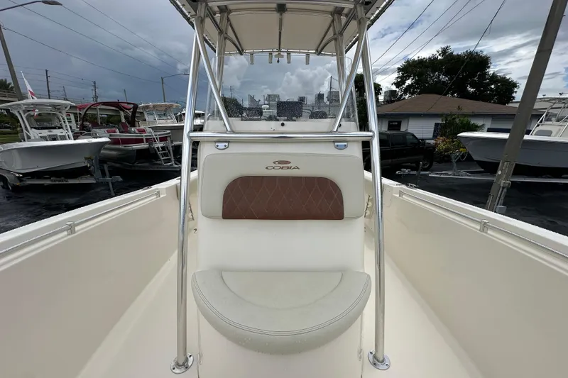 Slide: The Image of 2022 Cobia 237 Center Console boat interior with seating and console view. - 28