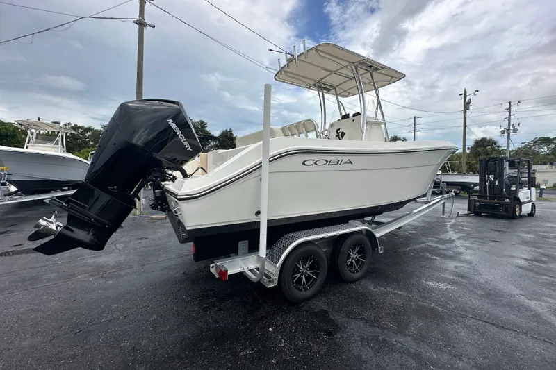 Slide: The Image of 2022 Cobia 237 Center Console boat on trailer with Mercury outboard motor. - 4