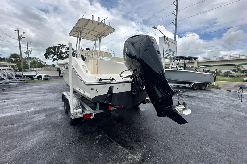 Slide: The Image of 2022 Cobia 237 Center Console boat on trailer with powerful outboard motor. - 7
