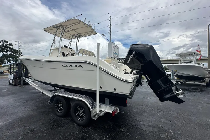 Slide: The Image of 2022 Cobia 237 Center Console boat on trailer, featuring Mercury outboard motor. - 8