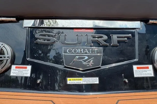 Slide: The Image of 2026 Cobalt R4 Surf boat rear view with logo and caution labels. - 10