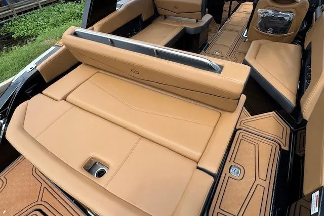 Slide: The Image of 2026 Cobalt R4 Surf boat interior with tan leather seating and modern design. - 13