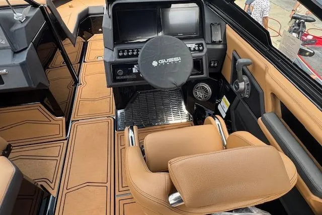 Slide: The Image of 2026 Cobalt R4 Surf boat interior with tan leather seating and modern dashboard. - 18