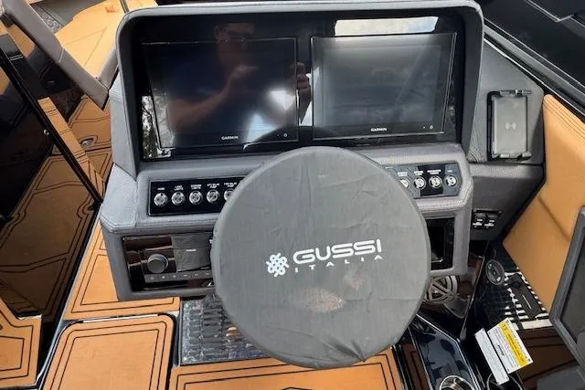 Slide: The Image of 2026 Cobalt R4 Surf boat dashboard with dual Garmin screens and Gussi Italia steering wheel. - 19
