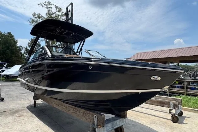 Slide: The Image of 2026 Cobalt R4 Surf boat on display, sleek black design, outdoor setting. - 4