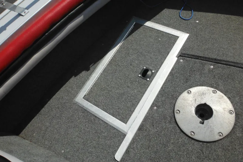 Slide: The Image of 1993 Sea Nymph SS175 Fish-n-ski boat interior with carpeted floor and storage hatch. - 11