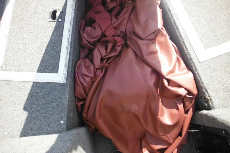 Slide: The Image of 1993 Sea Nymph SS175 Fish-n-ski boat interior with brown fabric and storage compartment. - 15