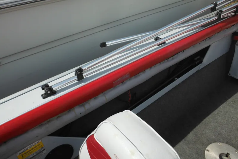 Slide: The Image of 1993 Sea Nymph SS175 Fish-n-ski boat interior with red trim and fishing rod holders. - 22