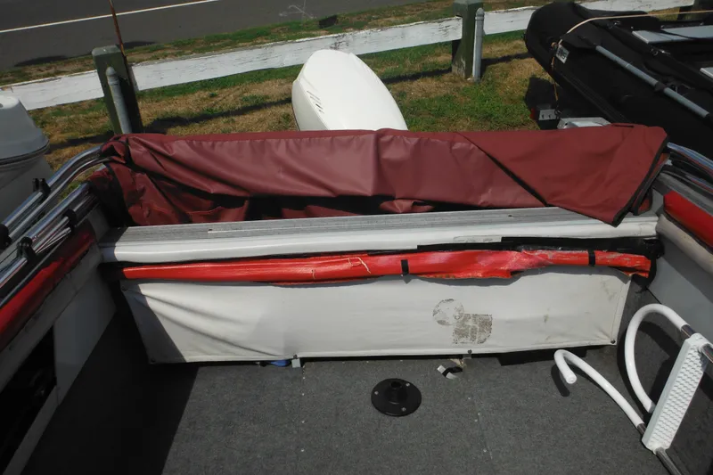 Slide: The Image of 1993 Sea Nymph SS175 Fish-n-ski boat interior with maroon cover and storage area. - 23