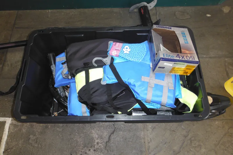 Slide: The Image of Box containing life jackets and Lowrance Elite-4x DSI fishfinder, related to 1993 Sea Nymph SS175 Fish-n-ski. - 29