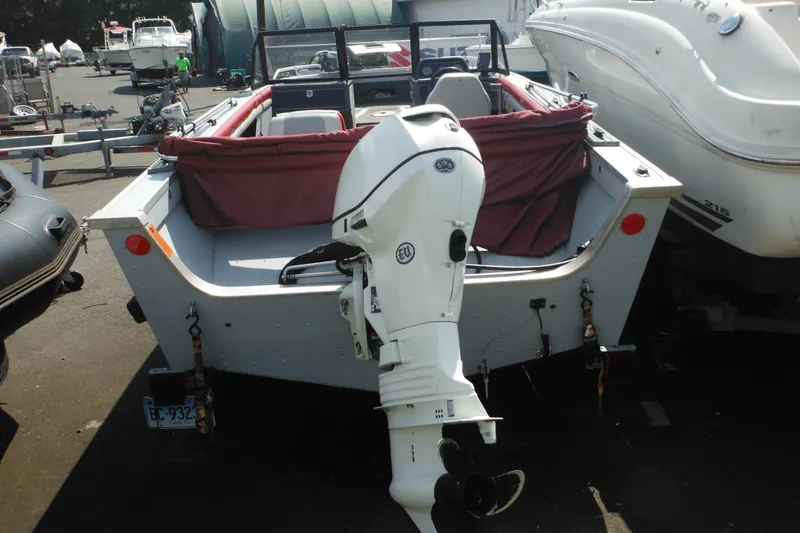 Slide: The Image of 1993 Sea Nymph SS175 Fish-n-ski boat with outboard motor, parked in a marina. - 3