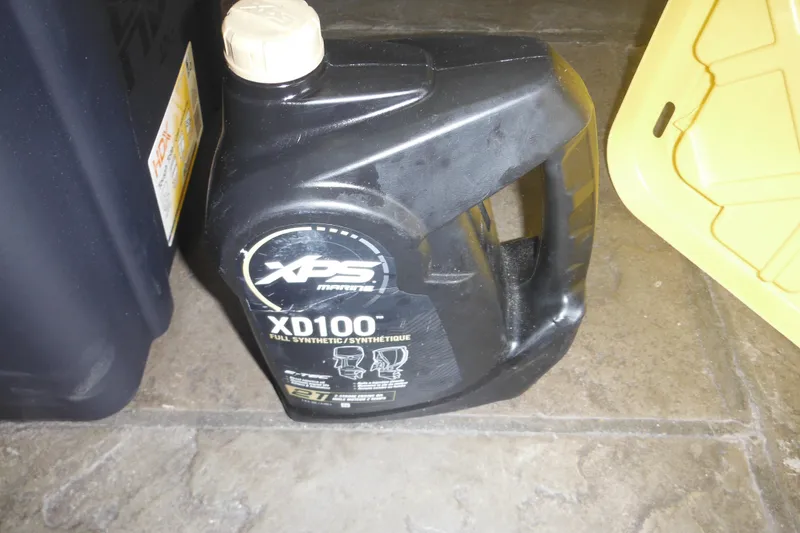 Slide: The Image of XPS Marine XD100 oil container on tiled floor, near yellow lid. - 31