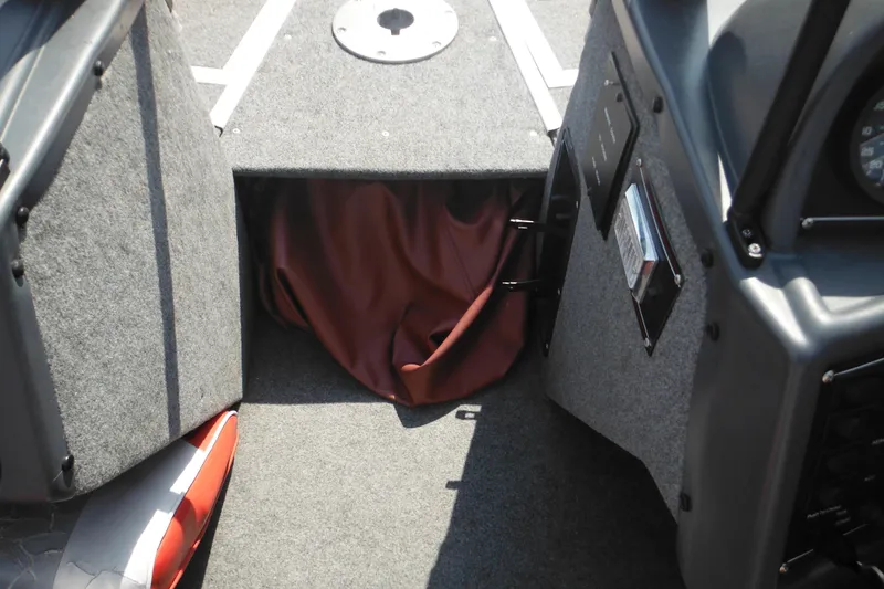Slide: The Image of 1993 Sea Nymph SS175 Fish-n-ski boat interior with carpeted flooring and storage compartment. - 8