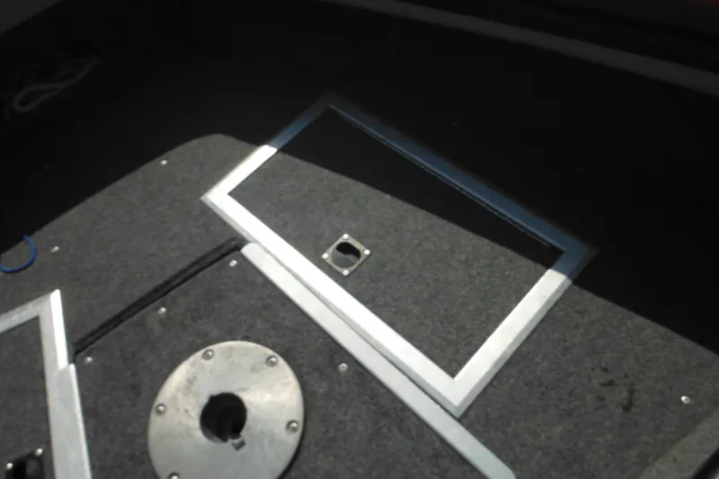 Slide: The Image of Interior of 1993 Sea Nymph SS175 Fish-n-ski boat, featuring carpeted flooring and storage hatch. - 9