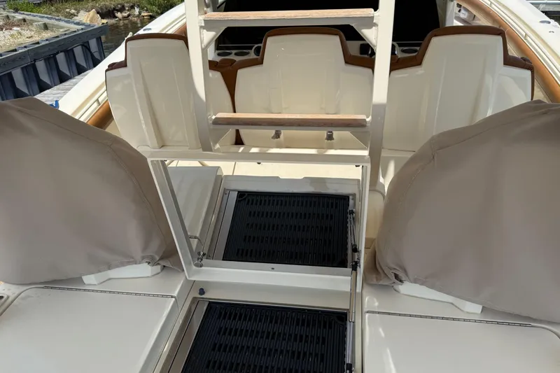 Slide: The Image of 2016 Scout 420 LXF boat interior with seating and ladder, showcasing luxury design. - 22