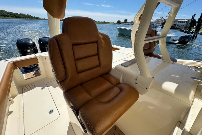 Slide: The Image of Luxurious seating on 2016 Scout 420 LXF boat with scenic water view. - 28