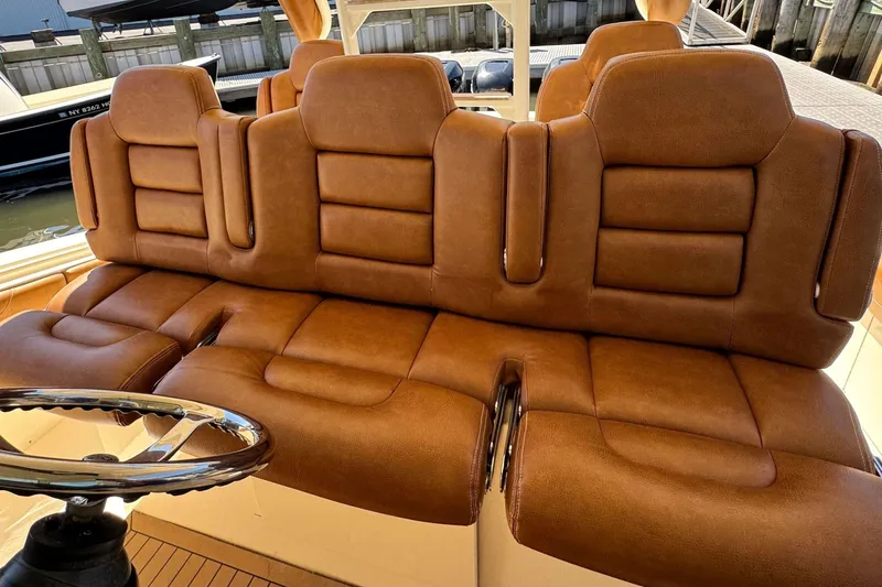 Slide: The Image of Luxurious brown leather seating on a 2016 Scout 420 LXF boat. - 32