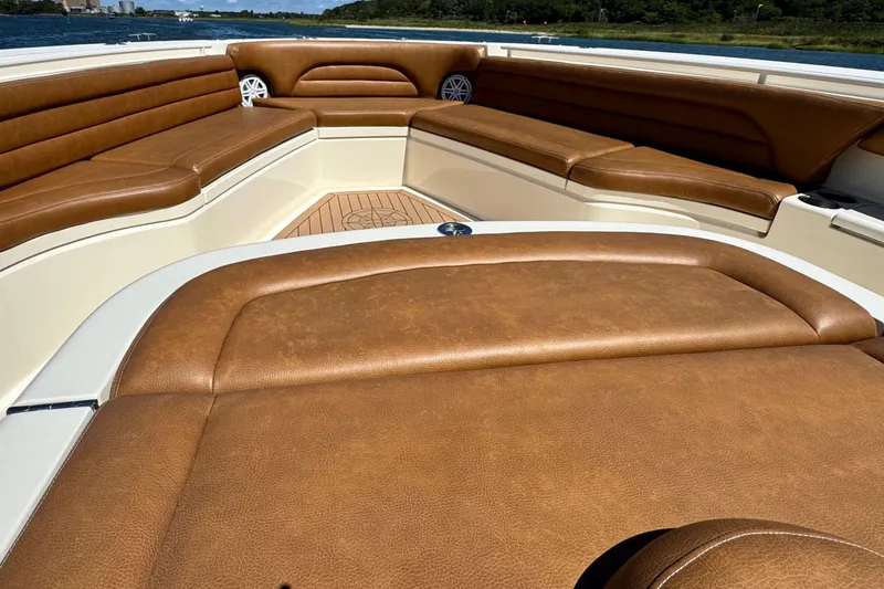 Slide: The Image of 2016 Scout 420 LXF boat interior with luxurious brown leather seating. - 40