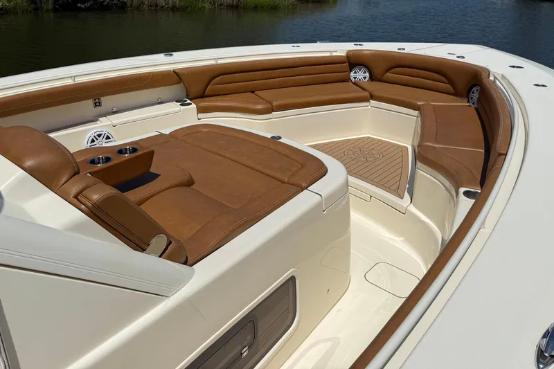 Slide: The Image of Luxurious seating area on a 2016 Scout 420 LXF boat with brown leather upholstery. - 41