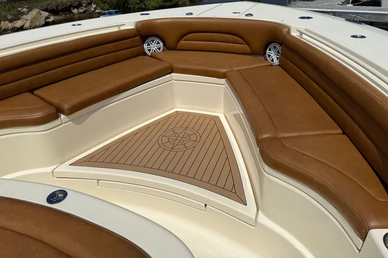 Slide: The Image of Luxurious seating area on 2016 Scout 420 LXF boat with brown leather cushions. - 45