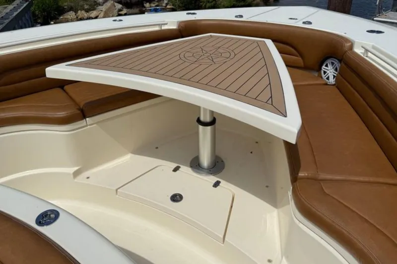 Slide: The Image of Luxurious seating area on 2016 Scout 420 LXF boat with elegant table design. - 46