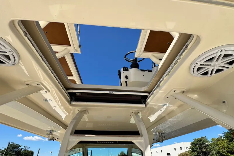 Slide: The Image of 2016 Scout 420 LXF boat interior view with open hatch and speakers. - 50