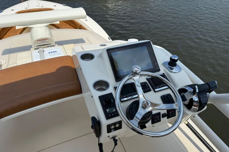 Slide: The Image of Helm of 2016 Scout 420 LXF boat with modern controls and navigation system. - 54