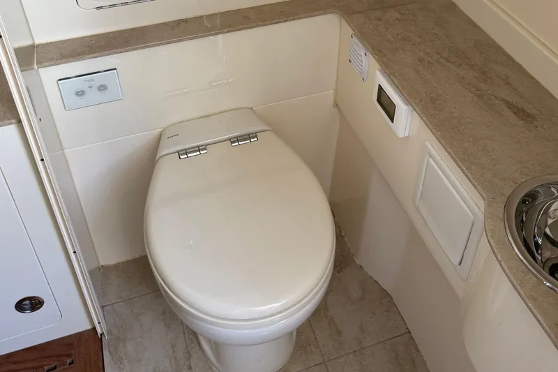 Slide: The Image of Luxury bathroom in 2016 Scout 420 LXF boat with modern toilet and countertop. - 61