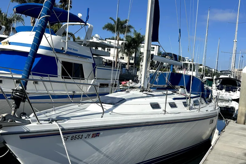 The Image of 1991 Catalina 42 MkII sailboat docked at marina, surrounded by other boats. - 0