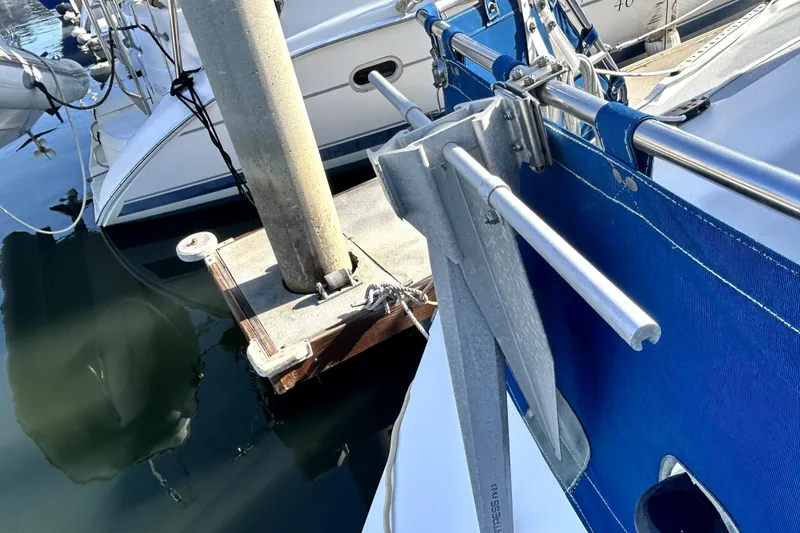 Slide: The Image of Docked 1991 Catalina 42 MkII sailboat with blue canvas and metal fittings. - 12