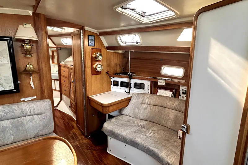 Slide: The Image of Interior of a 1991 Catalina 42 MkII sailboat with wood accents and cozy seating. - 4
