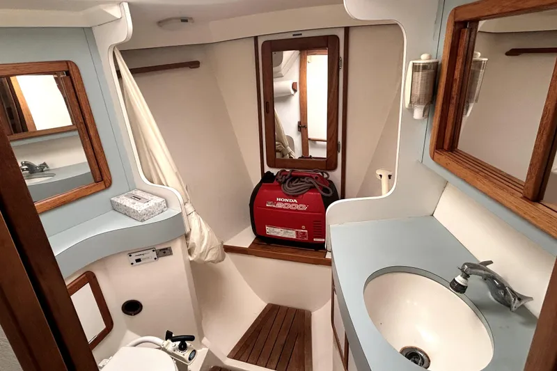 Slide: The Image of Bathroom interior of 1991 Catalina 42 MkII yacht with sink, mirror, and generator. - 5