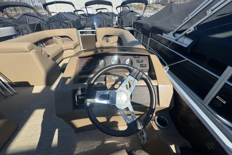 Slide: The Image of 2018 Bennington 23 SSBXP boat interior with steering wheel and dashboard controls. - 12